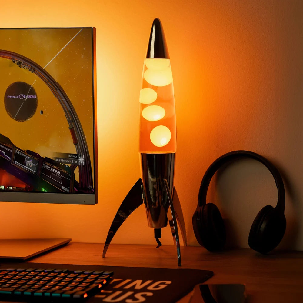 Fisura Raket Lavalamp met Oranje Lava - Chrome op de bureau als sfeerverlichting tijdens het gamen